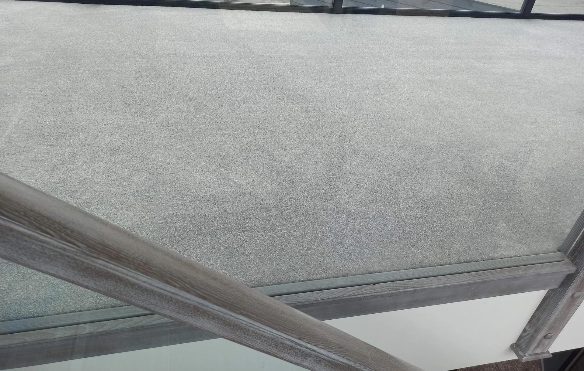 Freshly cleaned grey carpet in a bright conservatory